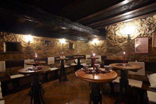 a dining room with tables and chairs and candles at Grobelnik Tourist Farm in Sevnica