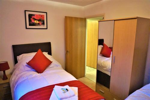 a small bedroom with a bed and a mirror at Palmer's Apartment in Bristol