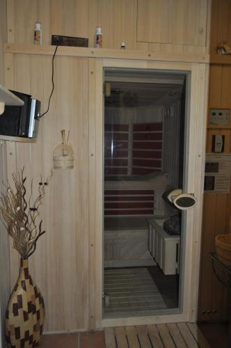a glass door in a room with a vase at Grobelnik Tourist Farm in Sevnica