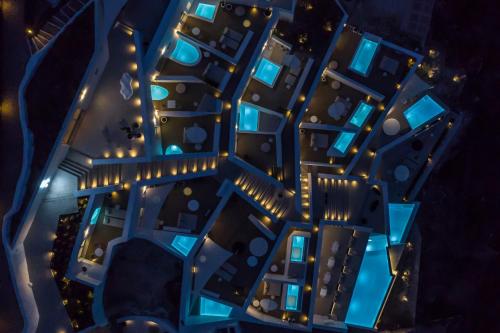 an overhead view of a city at night at The Saint Hotel in Oia