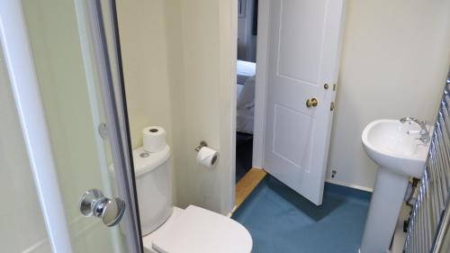 a bathroom with a toilet and a sink at Wadham College in Oxford