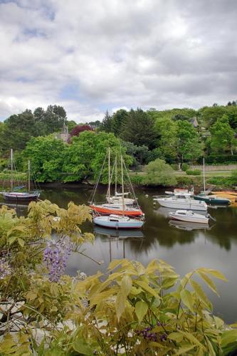 a group of boats are docked in the water at Hotel de charme Les Mimosas in Pont-Aven