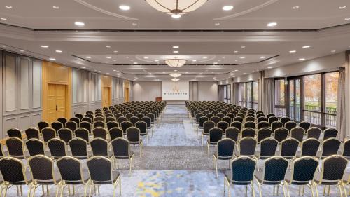 an empty room with a row of chairs and a stage at Bilderberg Bellevue Hotel Dresden in Dresden