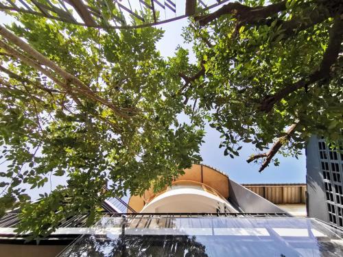a view of the facade of a building with trees at Pannana Cha-am in Cha Am