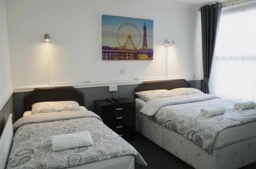 a bedroom with two beds and a ferris wheel at The Gurkha Hotel in Blackpool