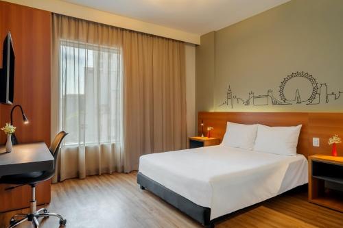 a hotel room with a bed and a desk at Ibis Styles SP Centro in Sao Paulo