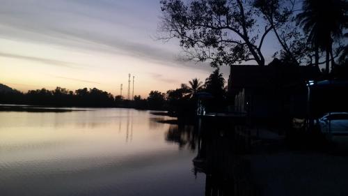 a view of a river at sunset at Khum Thong Resort in Takua Pa