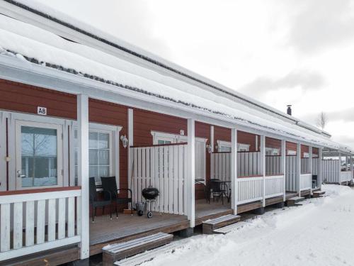 a house with a deck in the snow at Holiday Home Karitahko a 7 by Interhome in Tahkovuori