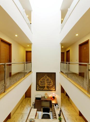 a large room with a staircase with a desk in it at Silver Oak @ 56A in Gurgaon