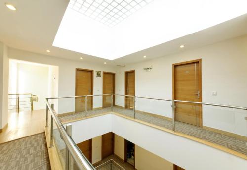 a staircase in a building with a skylight at Silver Oak @ 56A in Gurgaon