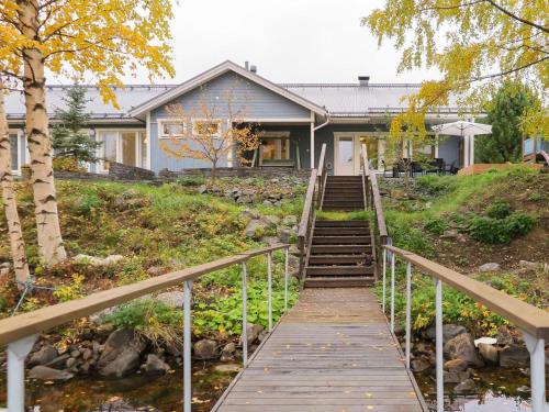 a house with a wooden walkway leading up to it at Holiday Home Villa lehmus by Interhome in Rovaniemi