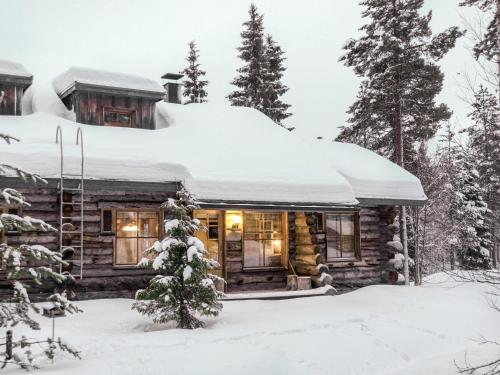 a log cabin in the snow at Holiday Home Kiiruna by Interhome in Sirkka