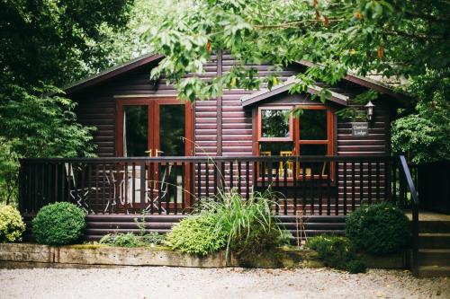 a log cabin with a porch and a window at Chycara in Truro