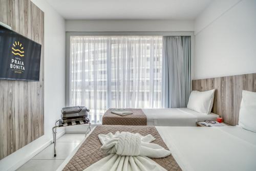 Łóżko lub łóżka w pokoju w obiekcie Hotel Praia Bonita Jatiúca