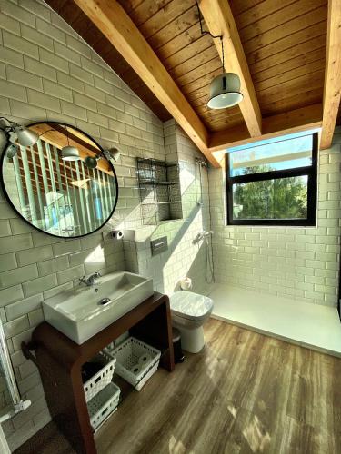 a bathroom with a sink and a toilet and a mirror at Cortijo Jamaro Boutique in Cehegín