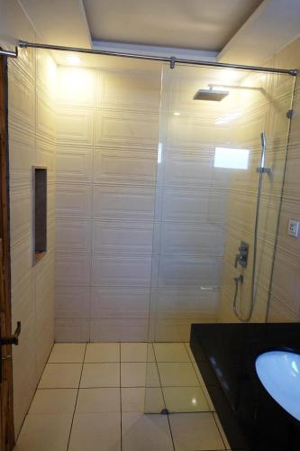a bathroom with a shower and a sink at Morgah Resort - Guest Rooms in Rawalpindi