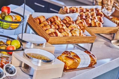 a table topped with lots of different types of pastries at Mercure Paris Orly Airport in Orly
