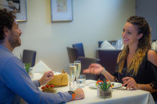 a man and a woman sitting at a table at Tuscany Inn in Montecatini Terme