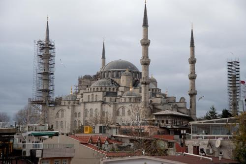 a building with two mosques in a city with buildings at Hotel Mevlana Bazaar in Istanbul