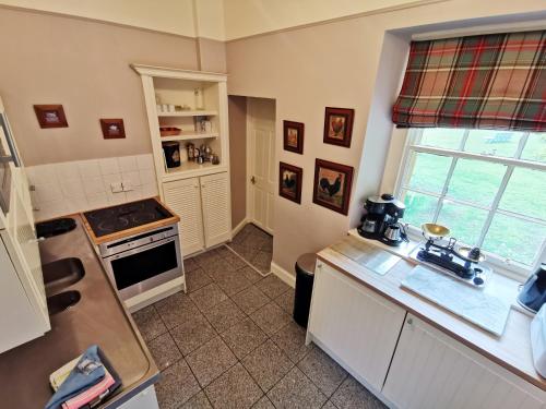 a kitchen with a sink and a stove top oven at Leithen Lodge in Innerleithen