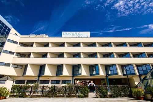 a white building with a sign on top of it at Tuscany Inn in Montecatini Terme