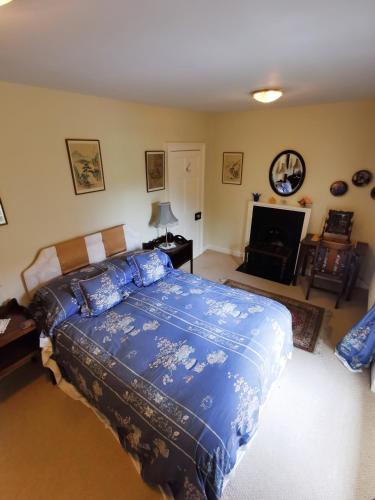 a bedroom with a bed with a blue comforter at Leithen Lodge in Innerleithen
