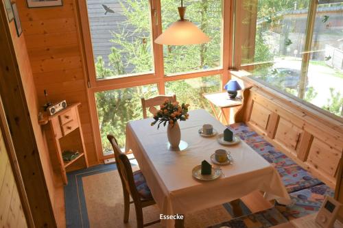 a room with a table with a vase of flowers on it at MaRei-Hütte in Hohentauern