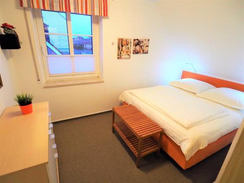 a small bedroom with a bed and a window at Blauort12 in Büsum