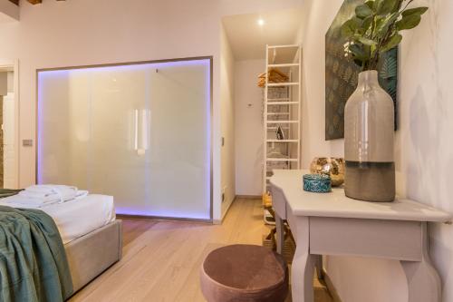 a room with a bed and a table with a vase on it at Home Venice Apartments - Biennale 1 - 2 - 3 in Venice