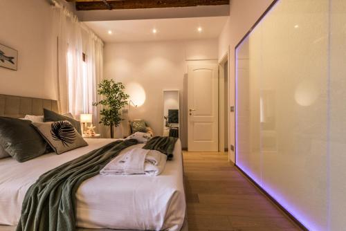 a bedroom with two beds and a glass wall at Home Venice Apartments - Biennale 1 - 2 - 3 in Venice