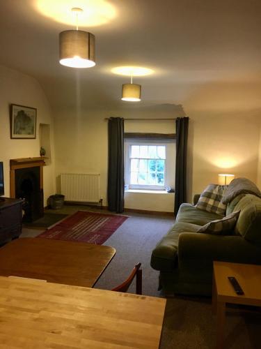 a living room with a couch and a table at Bank House | Peak District in Longnor