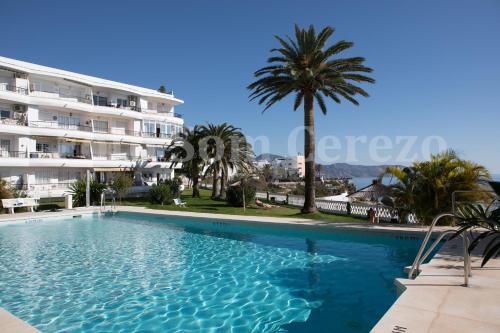 a large swimming pool in front of a building at Acapulco playa Nerja 407 planta superior in Nerja