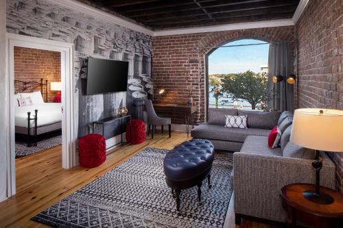 a living room with a brick wall at River Street Inn in Savannah