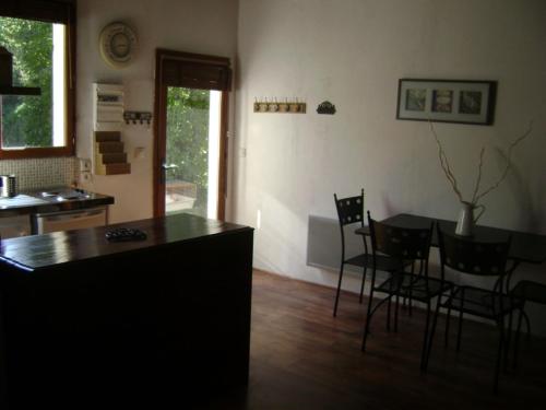 a kitchen and dining room with a table and chairs at fleur de neige in Gilly-sur-Isère