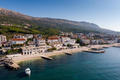 an aerial view of a beach with a boat in the water at Apartments Antonio - Podstrana, Split in Podstrana