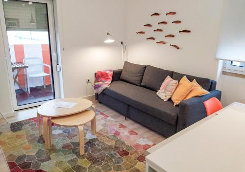 a living room with a couch and a table at Casas da Avó II in Santa Cruz