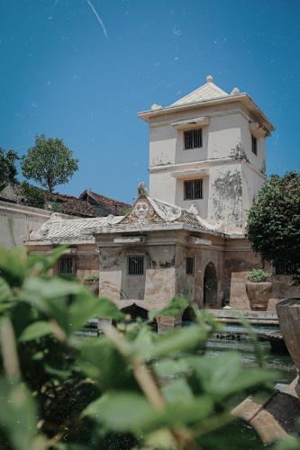 an old building with a tower on top of it at Griya Suryo Wijilan in Yogyakarta