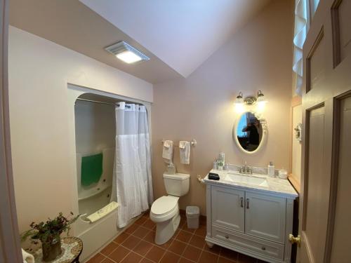 a bathroom with a toilet and a shower and a sink at Chambery Inn in Lee