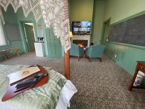 a bedroom with a bed and a chalkboard and a table at Chambery Inn in Lee