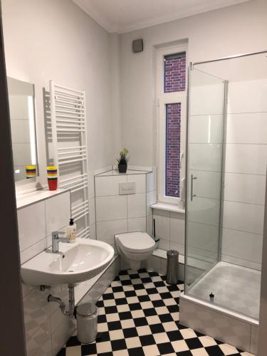 a bathroom with a sink and a toilet and a shower at meierstrasse in Lübeck
