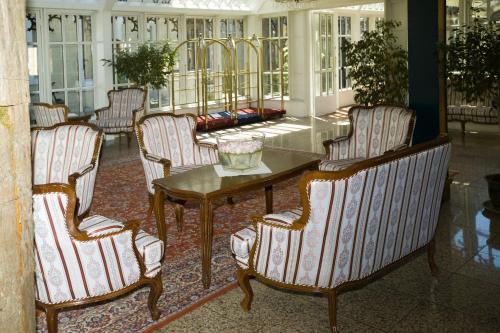 a group of chairs and a table in a room at Hotel Štekl in Hluboká nad Vltavou