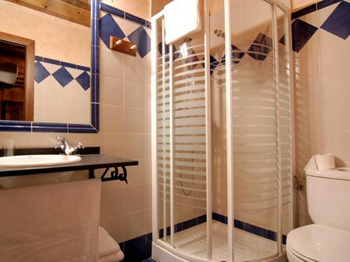 a bathroom with a shower and a toilet and a sink at La Casona del Herrero in Navaleno