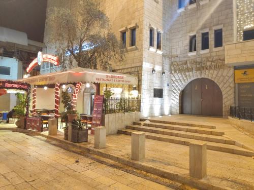 a building with stairs in front of a building at Dar Jacaman - In the heart of Bethlehem old city in Bethlehem