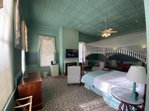 a bedroom with a large bed and a table at Chambery Inn in Lee