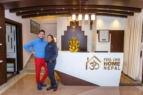 a man and a woman standing in front of a house at Feel Like Home Nepal in Kathmandu