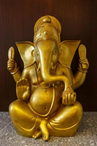 a gold elephant statue sitting on a table at Feel Like Home Nepal in Kathmandu