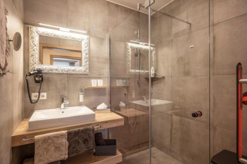 a bathroom with a sink and a shower at APART deluxe am Wilden Kaiser in Söll