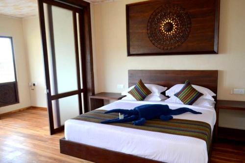 a stuffed animal laying on a bed in a bedroom at Guru Beach Resort in Tangalle