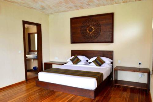 a bedroom with a large bed in a room at Guru Beach Resort in Tangalle