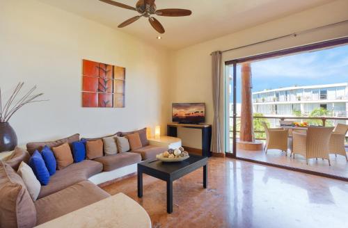 a living room with a couch and a table at Porto Playa Condo Hotel and Beach Club in Playa del Carmen